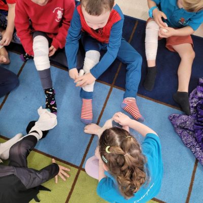 children learning how to bandage in junior safety and wellbeing class
