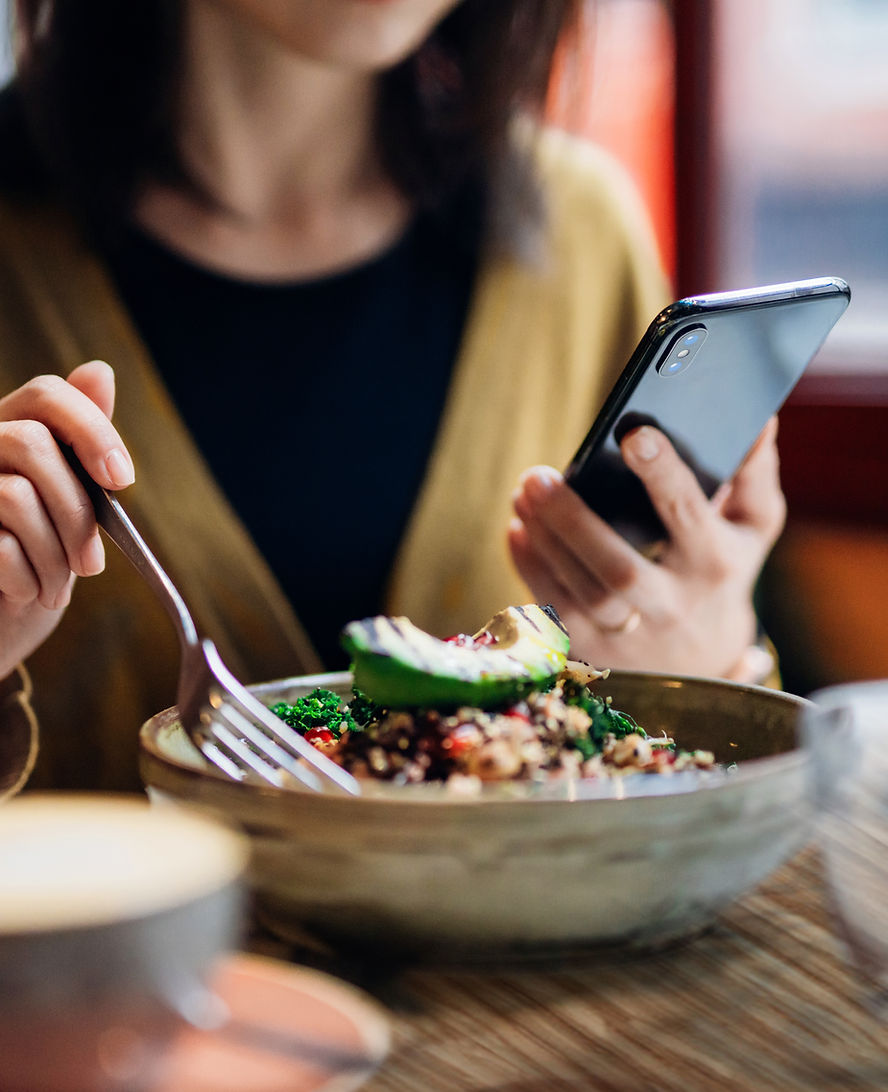 Lady on phone whilst eating lunch, try and create work life balance. FAST Training Australia teaches quick and easy self care strategies in their workplace training programs to help avoid burnout. 
