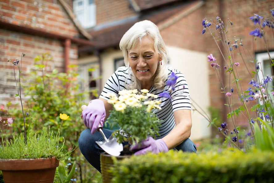 woman tending garden, fresh air is great for your mental health 