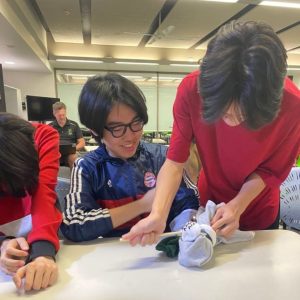 youth managing a bleed with a sock youth safety and wellbeing class
