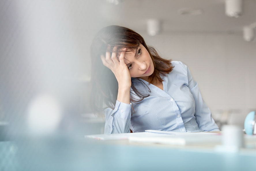 Woman with brain fog, providing mental health training can help your staff manage workplace stress and supporting your team. 