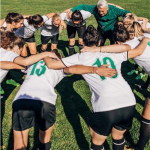 Soccer team huddling together on the field, prepare participants for a sports competition