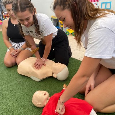 2 childcare educators completing HTLAID012 Provide First Aid in an Education and Care Setting course at their workplace