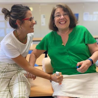 2 school teachers practising first aid management for anaphylaxis at staff First Aid and CPR Training. Offering Workplace First Aid Training in Brisbane and Ipswich.