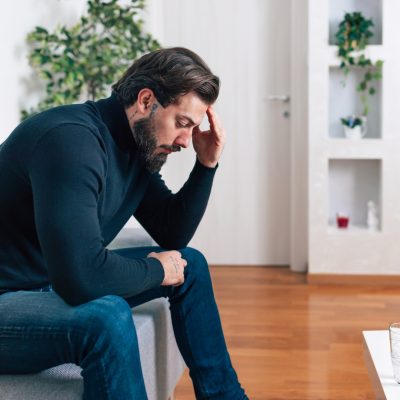 man with head in his hands. Mental Health First Aid Essentials Training