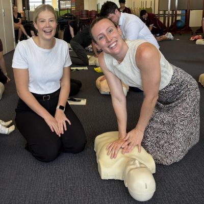 2 school teachers having fun during a cpr refresher course Ipswich, cpr certification