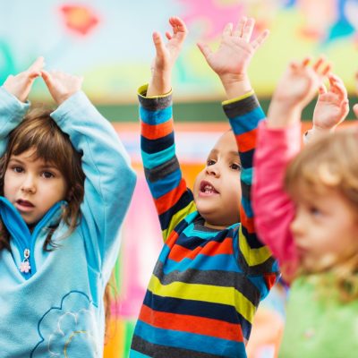kids dancing in junior safety and wellbeing class. it is important for children to move their bodies and learn how to regulate their own nervous system.