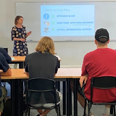 trainer teaching mental health awareness class at a workplace in Brisbane