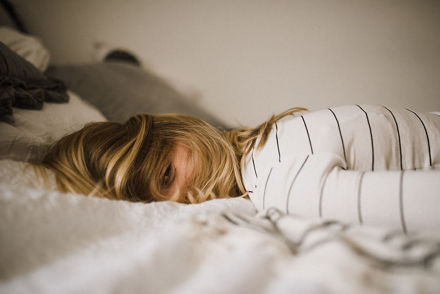lady exhausted on bed, why self care is not selfish. learn tips and strategies to improve your self care. Learn Mental Health First Aid at a course in Brisbane. 