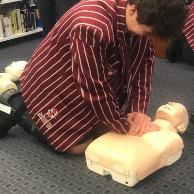 School Student doing CPR Training on a manikin at Ipswich Grammar School