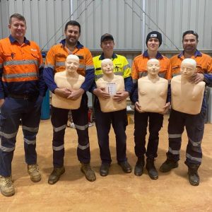 group of staff with manikins after staff training in cpr lvr and first aid at a workplace in brisbane