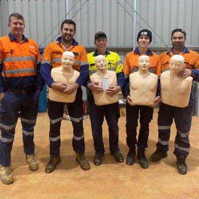 group of staff with manikins after staff training in cpr lvr and first aid at a workplace in brisbane