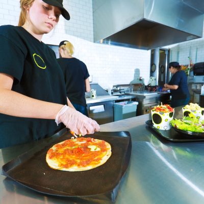 teenager serving food after a food safety course