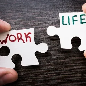 two jigsaw pieces 'work' and 'life', managing work life balance.