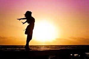 woman at sunset prioritising wellbeing