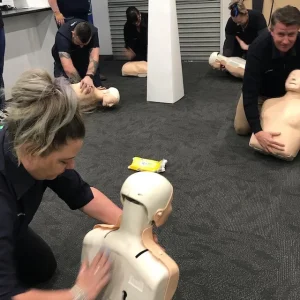 Person delivering a back blow at First Aid Training - first aid compliance