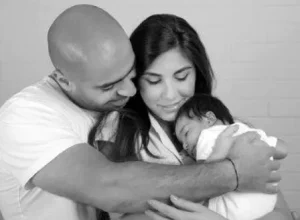 Mum and dad bonding with their baby