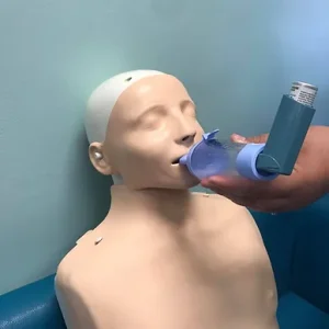 Using a ventolin spray. Asthma awareness and asthma training