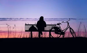 lady-sitting-on-bench-sunset