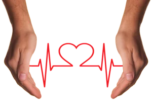 heart symbol between a persons hands learn first aid