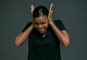 lady covering ears painful Autism Spectrum Disorder